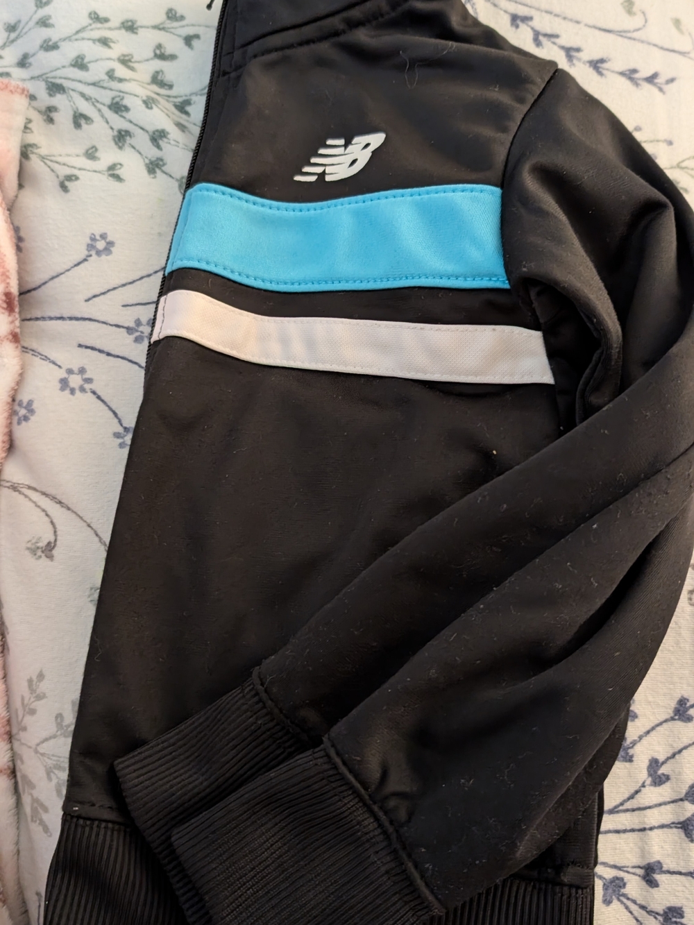 New Balance Black Jacket with Blue and White Stripes